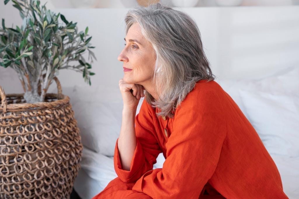older woman with orange clothes free menopause tracker app
