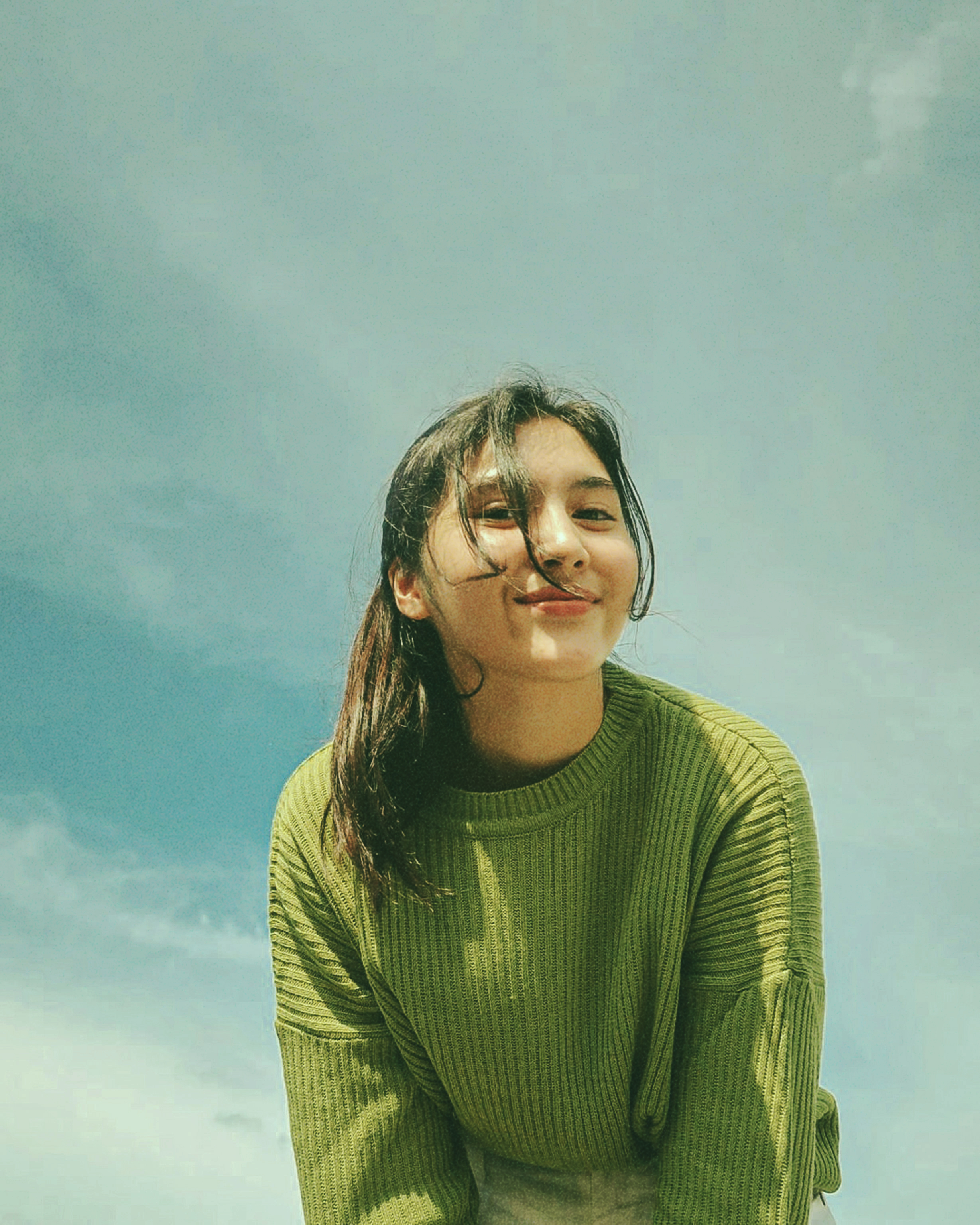 girl with a half-smile standing