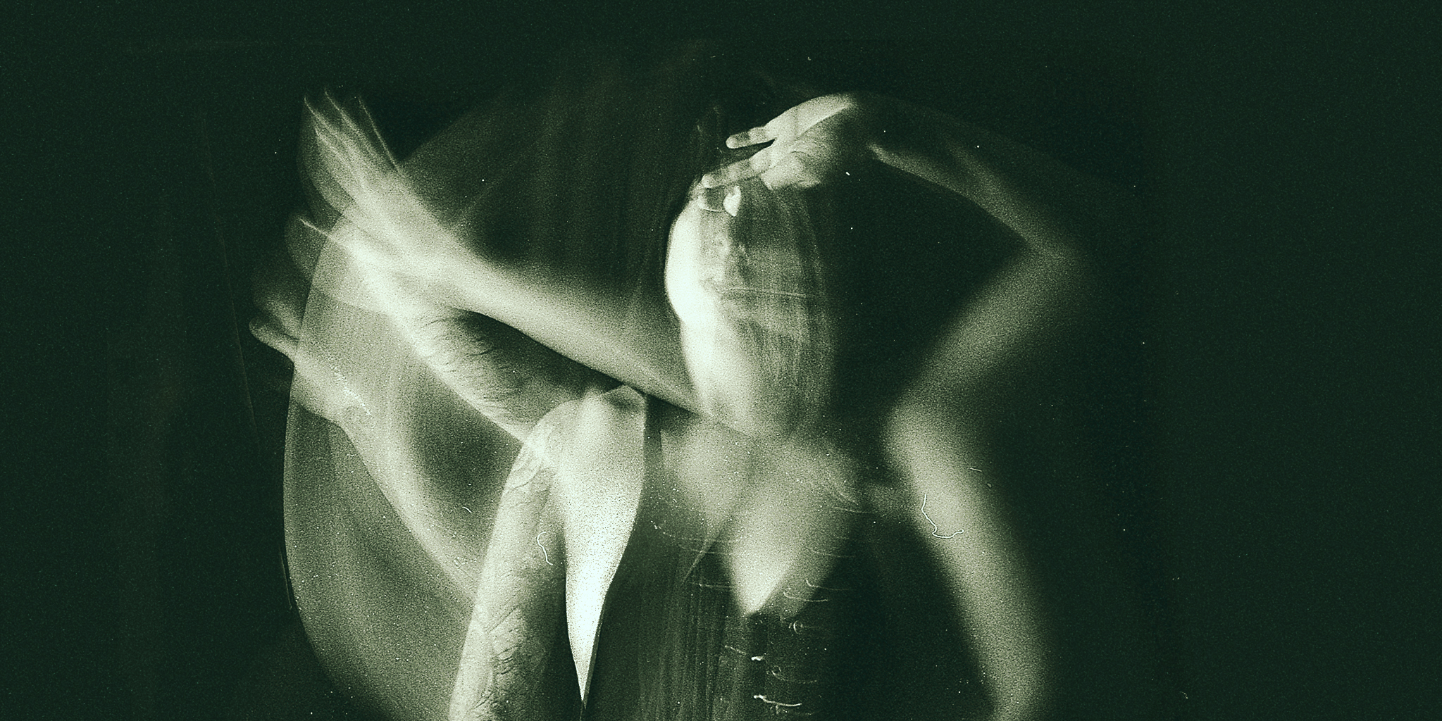 A blurred image of a woman with multiple overlapping poses, conveying a sense of movement and confusion. The image has a dark and moody tone, symbolizing emotional turmoil.