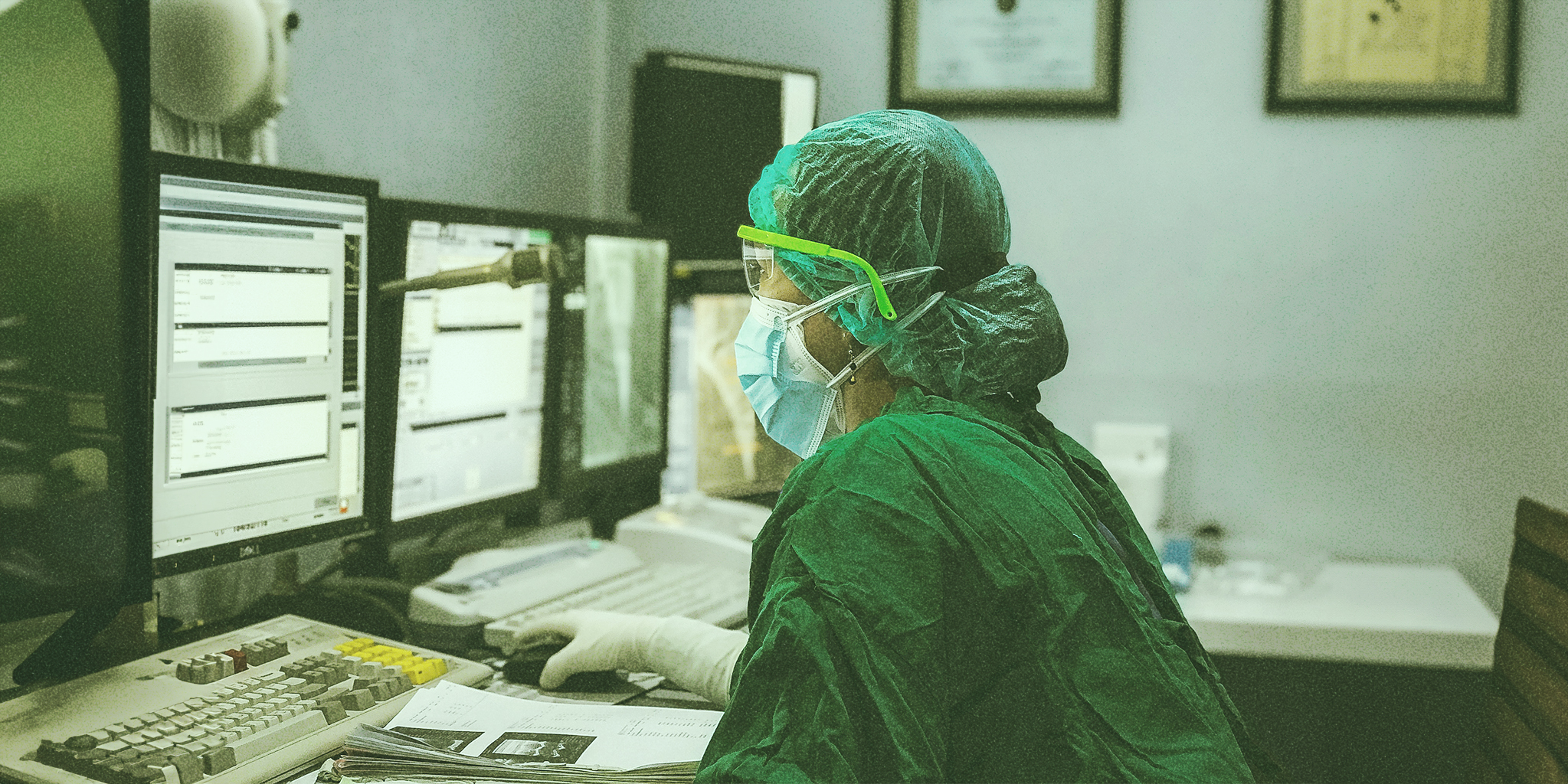 A doctor, sitting in front of a computer, appears focused on the screen. The image explores whether an endocrinologist can help with PMDD, highlighting potential medical interventions and support.