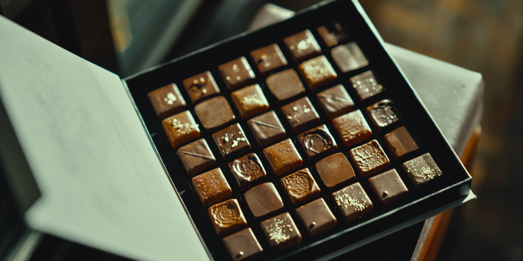 Why Do I Crave Chocolate On My Period? A box of luxurious chocolates with golden details